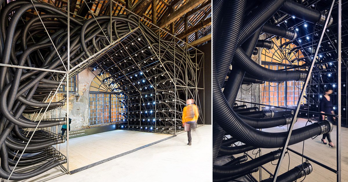 a web of black pipes explores human resistance to technology at venice biennale - Designboom